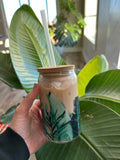 Clear tropical foliage can glass